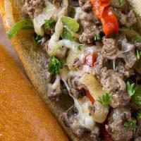 Philly Cheesesteak With Chips And Drink · * Thinly sliced halal grilled sirloin steak & bell peppers,  onions topped with melted Ameri...