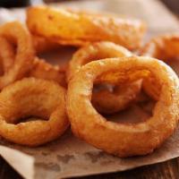 Onion Rings · Basket of rings with a side of ranch.