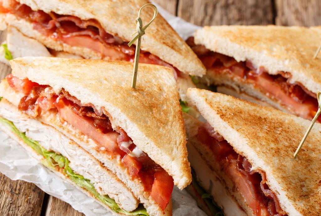 Turkey Club · Thick sliced turkey breast with lettuce, tomato, bacon, mayo, on toasted wheat bread, comes with a bag of chips
