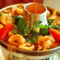 Tom Yum Goong · Hot and sour soup with shrimp, mushrooms, lime juice, lemongrass, garnished with green onion...