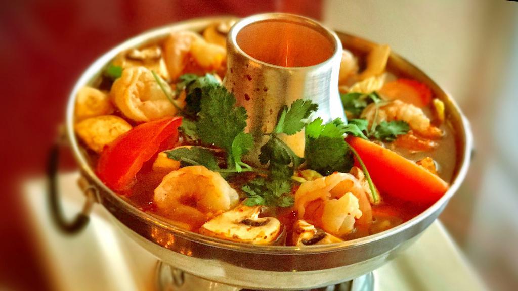Tom Yum Goong · Hot and sour soup with shrimp, mushrooms, lime juice, lemongrass, garnished with green onion and cilantro traditional Thai-chili paste.