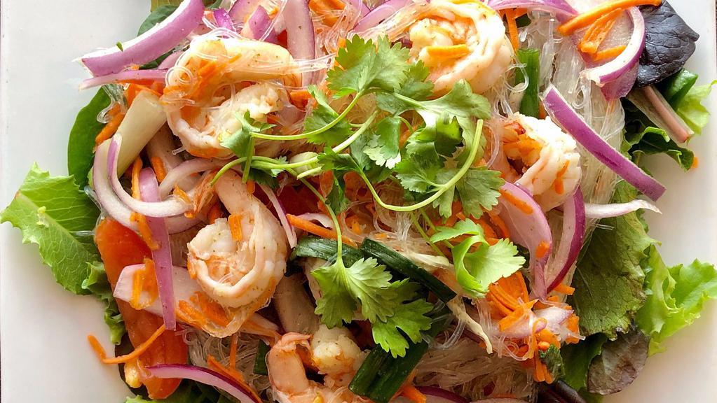 Glass Noodle Salad · Bean thread noodles mixed with shrimp, ground chicken, onions, carrots, celery, finished with our traditional chili-lime dressing.