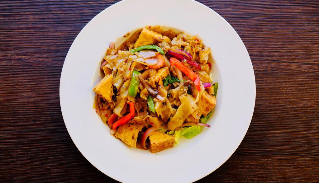 Spicy Kee Mao Noodles · Spicy pan-fried rice noodles with eggs, bell peppers, onions, tomatoes, Thai basil and finished with a spicy red garlic sauce.