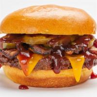 Cowboy Burger · A beef burger topped with cheddar, bacon, fire-roasted corn and poblano salsa and BBQ sauce ...