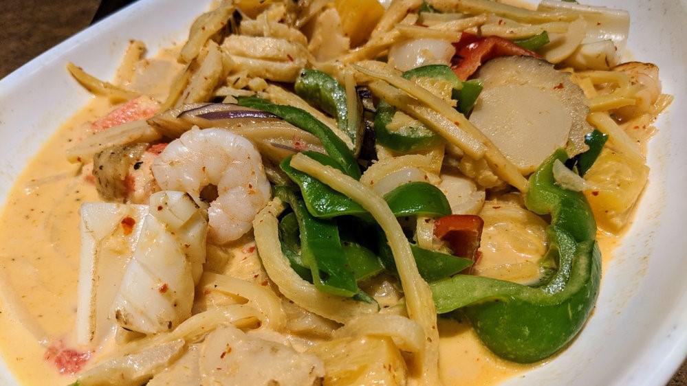 Seafood Curry · Spicy. Gluten free.  Shrimp, squid, scallop and imitation crab with bell pepper, bamboo strip, eggplant, water chestnut and pineapple in red coconut curry sauce.