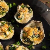 Oysters Rockefeller · Baked with kale, garlic butter, and parmesan cheese