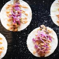 Blackened Fish Taco (3Pc) · Topped with cream cheese, homemade pickled onions & cabbage and cotija cheese