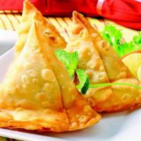Vegetable Samosa · Two triangular pastries stuffed with potatoes and green peas. Served with mint and tamarind ...