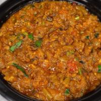 Begun Bharta · Eggplant baked, mushed and cooked with onions and tomatoes. Served with rice.