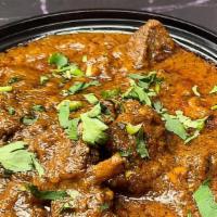 Goat Curry · Goat made with traditional Indian curry sauce. Served with rice.
