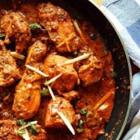 Chicken Karahi · Chicken in a curry with tomatoes, Ginger & Garlic. Served with rice.