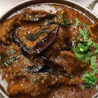 Goat Madras · Goat in a spicy curry with coconut. Served with rice.