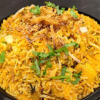 Chicken Biryani · A classic dish cooked with chicken, nuts and raisins with basmati rice. Served with raita.