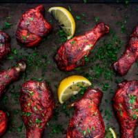 Tandoori Chicken · Bone-in chicken marinated in yogurt, spices, herbs, and barbecued in the clay oven. Served w...