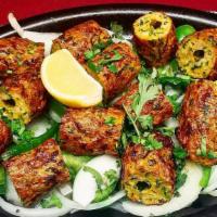 Lamb Seekh Kebab · Minced lamb blended with herbs and spices roasted on skewers. Served with rice.