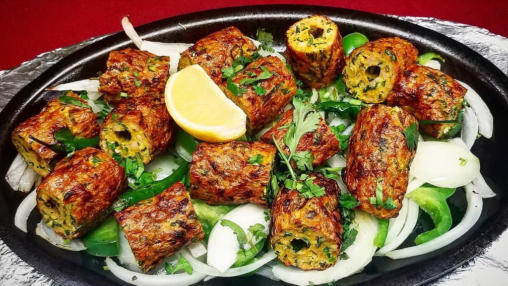 Lamb Seekh Kebab · Minced lamb blended with herbs and spices roasted on skewers. Served with rice.