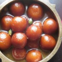 Gulab Jaman · A light pastry made with milk and honey served in a thick sugar syrup.