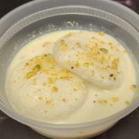 Rasmalai · Cottage cheese and milk flavored with rose water and garnished with nuts.