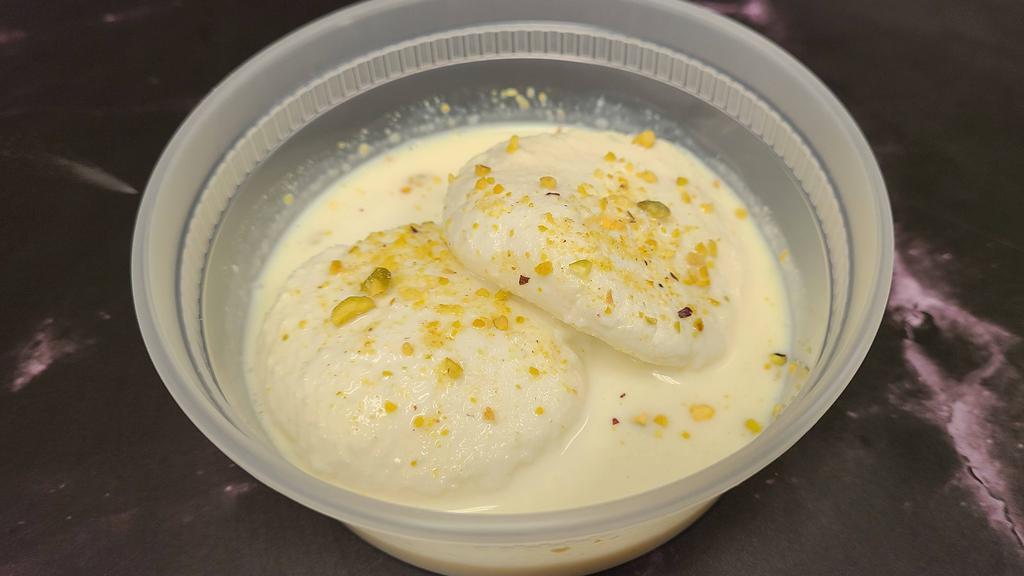 Rasmalai · Cottage cheese and milk flavored with rose water and garnished with nuts.