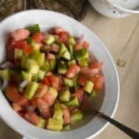 Salad Shirazi · Chopped tomatoes, onions, cucumber, mixed with olive oil, and lemon juice.