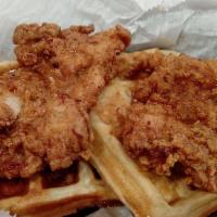 Chicken & Waffles · Two fried chicken breast on top of waffles with butter & syrup.