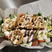 Burger Salad · Burger over mixed greens topped with red onion, avocado, tomatoes, goat cheese, onion straws...