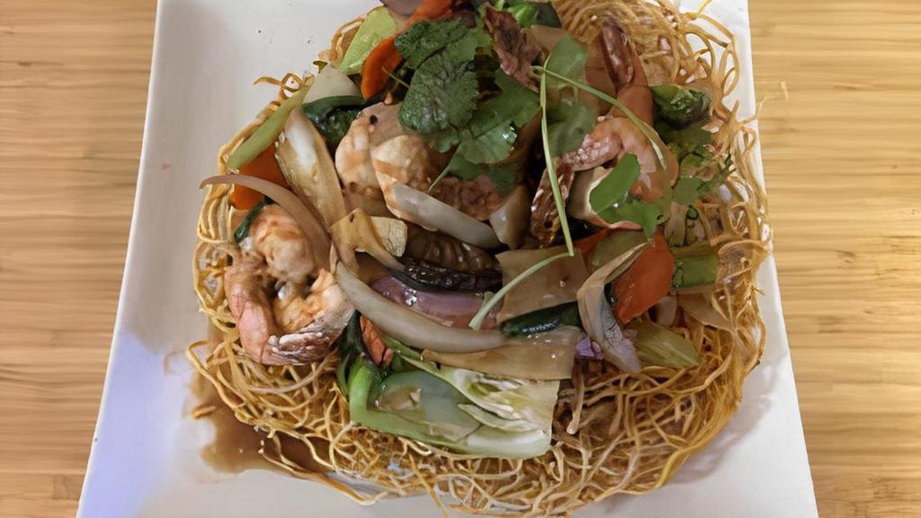 Seafood Bird'S Nest · stir-fried tiger prawns, calamari, mushrooms and garden
vegetables tossed in rice wine and oyster sauce, served on
a nest of crispy eggs noodles
