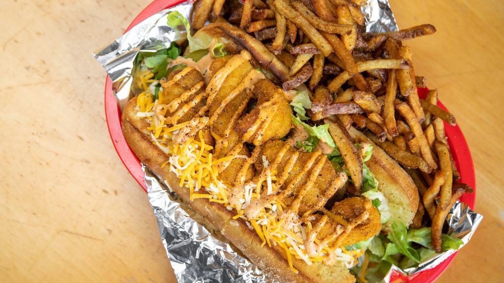 Catfish Po'Boy · Popular. fried catfish, cajun mayo, lettuce, tomato, shredded cheese and pickles on buttered French bread. Comes with fresh cut fries.