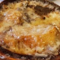 French Onion Soup · Topped with a crouton and melted Swiss cheese.