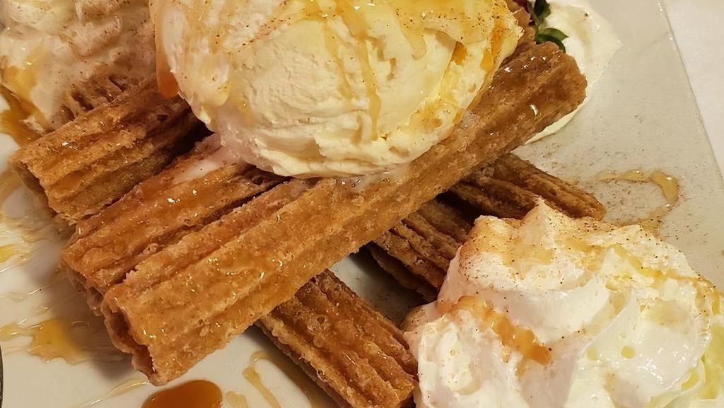 Churros · Fried dough pastries, served with honey and caramel sauce, dusted with cinnamon and sugar and topped with vanilla ice cream & whipped cream.