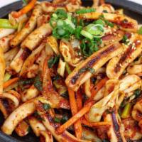Squid Stir Fry · Savory squid stir-fry with cabbage, carrot, onion, and scallion with a side of rice. One of ...