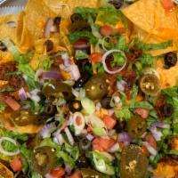 101 Nachos · Tortilla chips, jalapeños, onions, black olives, tomatoes, black beans, cheddar cheese.