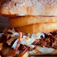 Pulled Pork Sandwich · Topped with onion rings and house slaw.