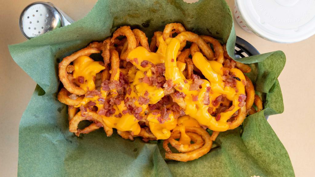 Loaded Curly Fries · Our secretly Seasoned French Fries covered in melted cheese and bacon bits. Mouth waveringly delicious!