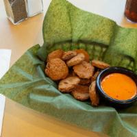 Pickle Chip Appetizer · Sharable portion of Fried Pickle Chips with Boom Boom Sauce for dipping purposes.