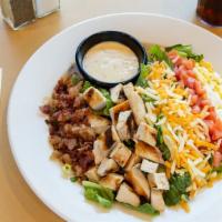 Cobb Salad · A beautiful combination of juicy grilled chicken, crisp bacon, hard-boiled egg, diced tomato...
