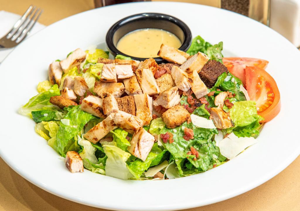 Caeser Grilled Chicken Salad · Crisp romaine, in our house Caesar dressing with croutons, tomato, shredded Parmesan cheese and bacon bits topped with grilled chicken.
