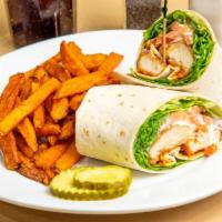 Buffalo Chicken Wrap · Breaded and fried buffalo style chicken tenders served with crisp lettuce, tomato and bleu c...