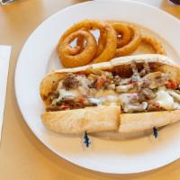 Philly Cheese Steak Sandwich · Tender, shaved steak smothered with onions and melted cheese on a toasted fresh torpedo roll.
