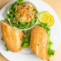 Fish Sandwich · Golden fried fish served with lettuce & tomato on a toasted French baguette.