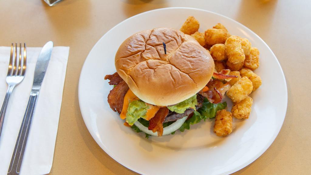Avacado Bacon Burger · Avacado slices tops this Big Beef burger along with bacon, lettuce, tomato, onions and secret sauce. All on a garlic butter grilled Brioche roll.