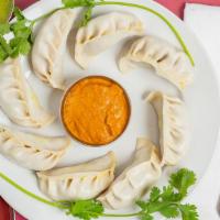 Lumbini Momo (Chicken) · Fresh ground chicken mixed with minced onions, cilantro, garlic and momo spices, delicately ...