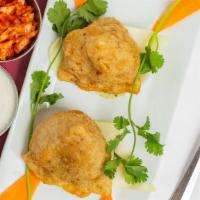 Veggie Samosa · Vegetarian. Crisp fried turnover filled with delicious mildly spiced potatoes, green peas, c...