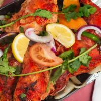 Tandoori Chicken(Whole) · Tender chicken marinated overnight with spices, yogurt and barbecued in the tandoor.
