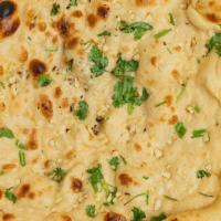 Garlic Naan · Vegetarian. Leavened bread topped with chopped garlic and green pepper and baked in a tandoor.