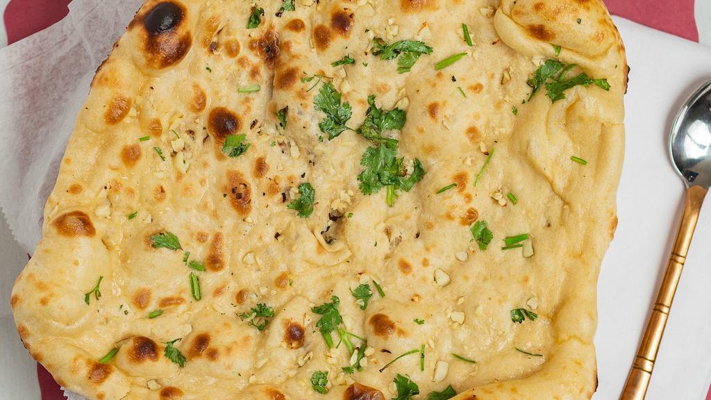 Garlic Naan · Vegetarian. Leavened bread topped with chopped garlic and green pepper and baked in a tandoor.