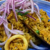 Arroz De Mariscos · “Seafood rice”. Marinated in our seafood. sauce, parmesan, filled with calamari, shrimp, mus...
