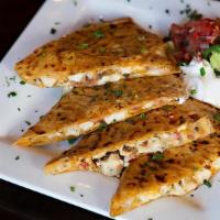Chipotle Quesadillas · Chipotle tortilla with a blend of 5 cheeses, pico de gallo, and chicken. Served with Chipotl...