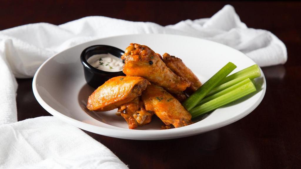 Buffalo Chicken Wings · One-pound of mouth-watering fried chicken wings tossed in Buffalo-style hot pepper sauce. Served with celery sticks and choice or bleu cheese or ranch dressing.