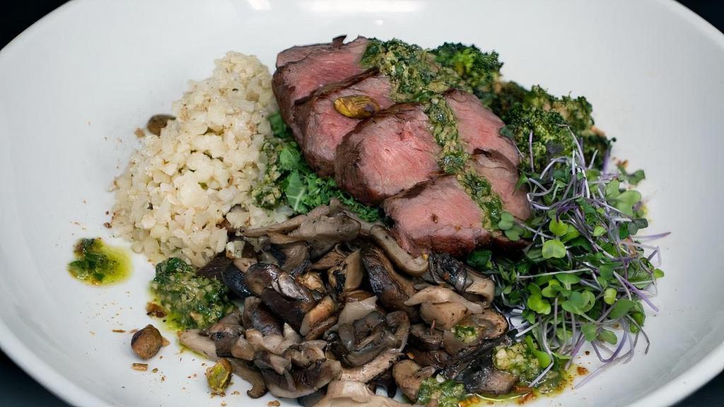 Keto Bowl · Wood-grilled Angus beef Sirloin served over a hearty mix of cauliflower “rice”, garlic-roasted broccoli, wild mushrooms, local microgreens, house-made basil pesto, fresh kale, and toasted pistachios.
